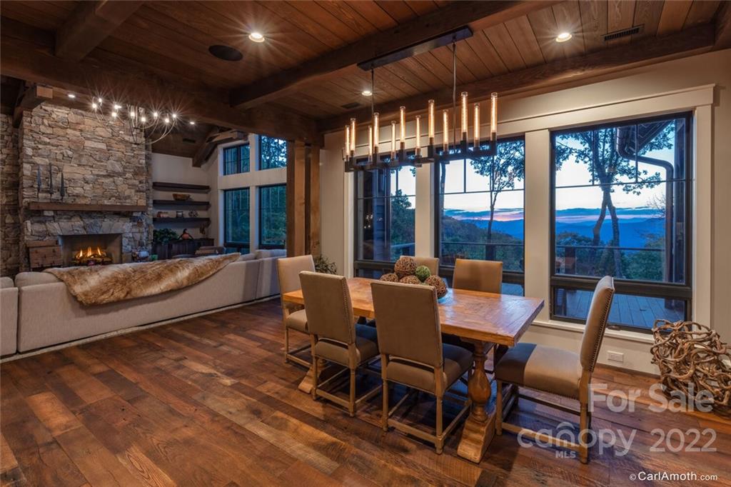 61 Back Bone Way, Unit 203 Sylva, NC 28779 - Photo 13 of 48 a view of a dining room with furniture a chandelier and wooden floor
