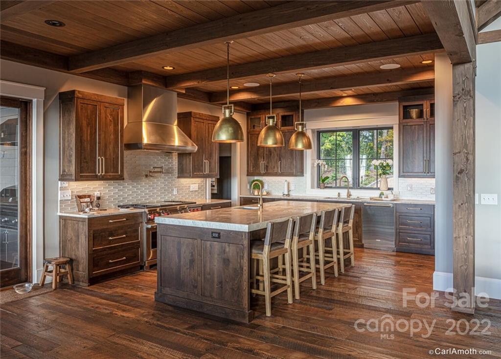 61 Back Bone Way, Unit 203 Sylva, NC 28779 - Photo 15 of 48 a kitchen with stainless steel appliances granite countertop a stove and a refrigerator