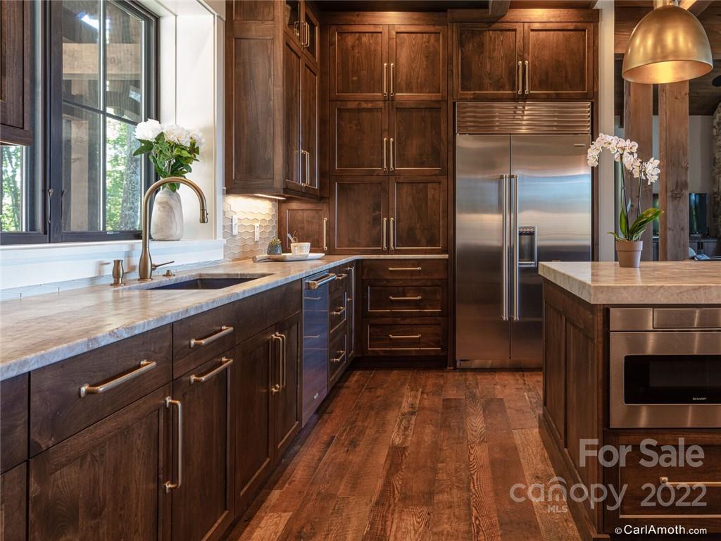61 Back Bone Way, Unit 203 Sylva, NC 28779 - Photo 18 of 48 a kitchen with stainless steel appliances a sink and a microwave