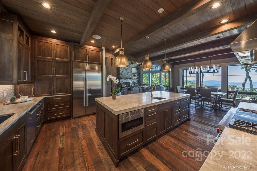 61 Back Bone Way, Unit 203 Sylva, NC 28779 - Photo 19 of 48 a kitchen with stainless steel appliances granite countertop a stove a sink and a refrigerator