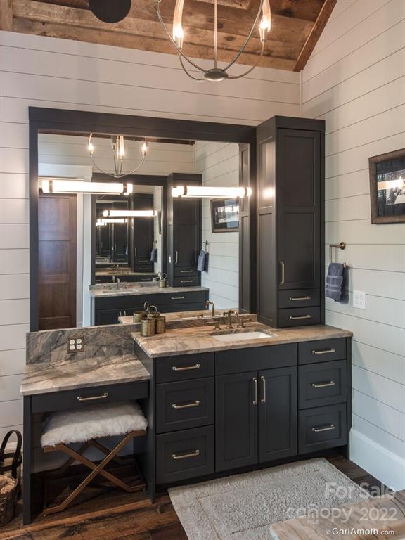 61 Back Bone Way, Unit 203 Sylva, NC 28779 - Photo 26 of 48 a bathroom with a sink a vanity and a large mirror