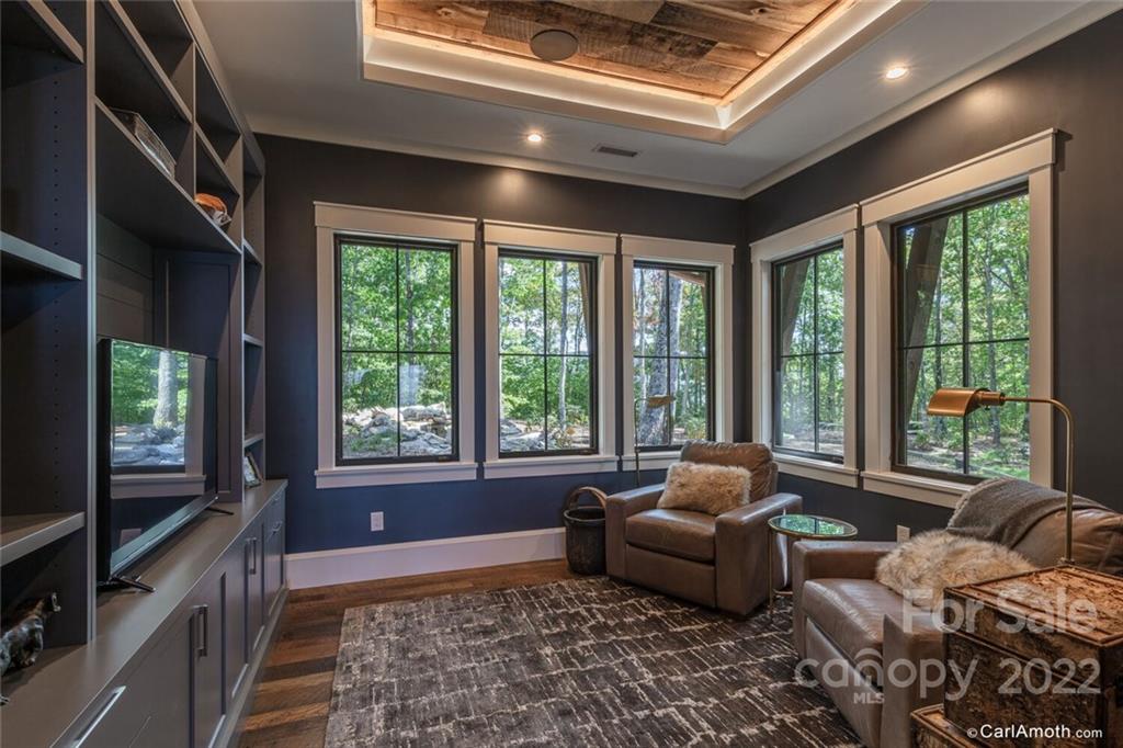 61 Back Bone Way, Unit 203 Sylva, NC 28779 - Photo 28 of 48 a living room with furniture and a flat screen tv