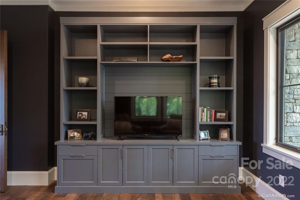 61 Back Bone Way, Unit 203 Sylva, NC 28779 - Photo 29 of 48 a living room with a fireplace and a flat screen tv