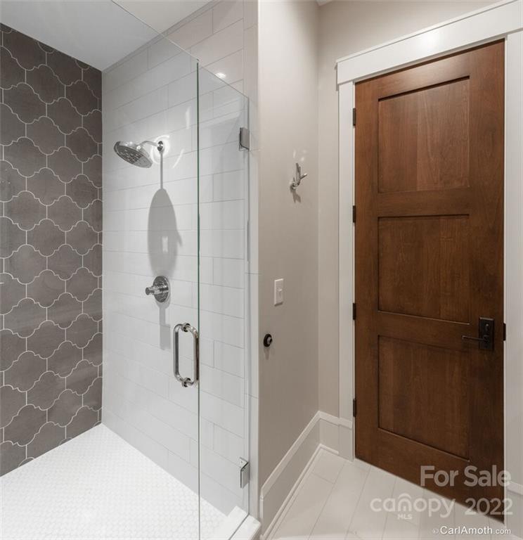 61 Back Bone Way, Unit 203 Sylva, NC 28779 - Photo 37 of 48 a bathroom with a shower and a sink