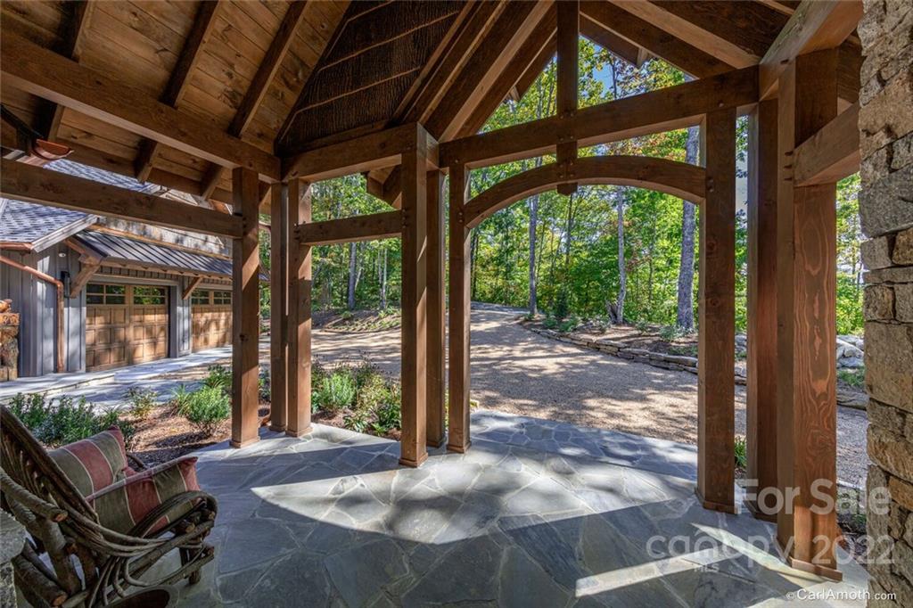 61 Back Bone Way, Unit 203 Sylva, NC 28779 - Photo 4 of 48 a view of a porch with furniture and a yard