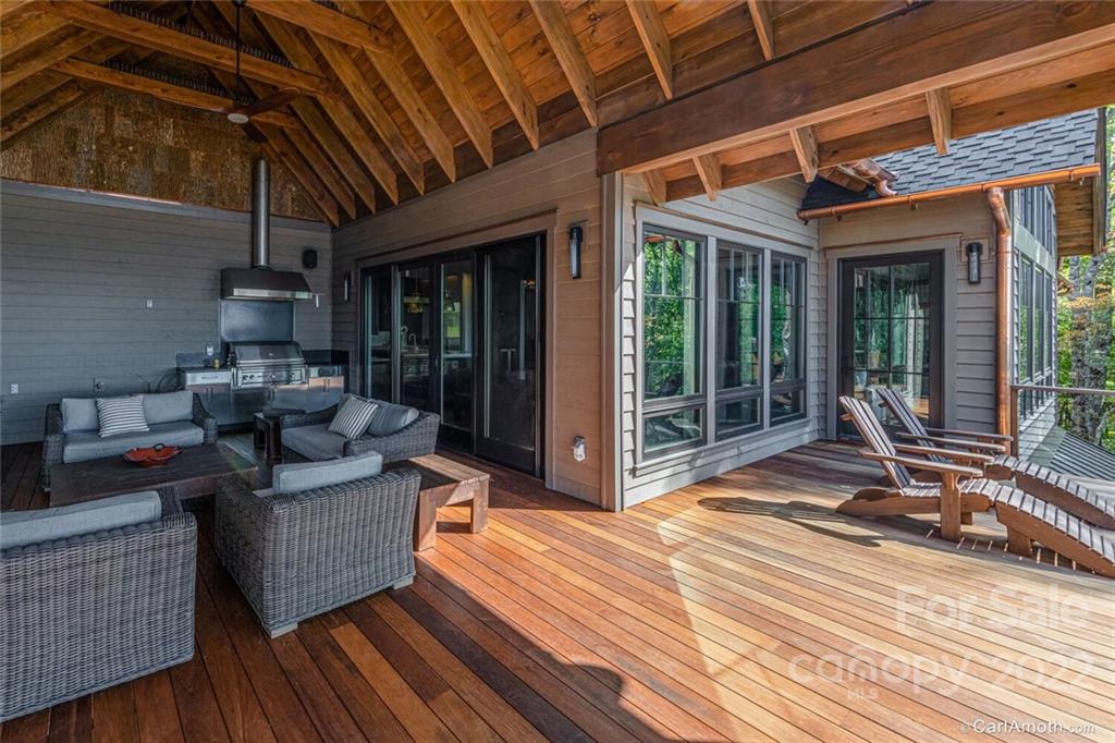 61 Back Bone Way, Unit 203 Sylva, NC 28779 - Photo 46 of 48 a view of a patio with table and chairs wooden floor