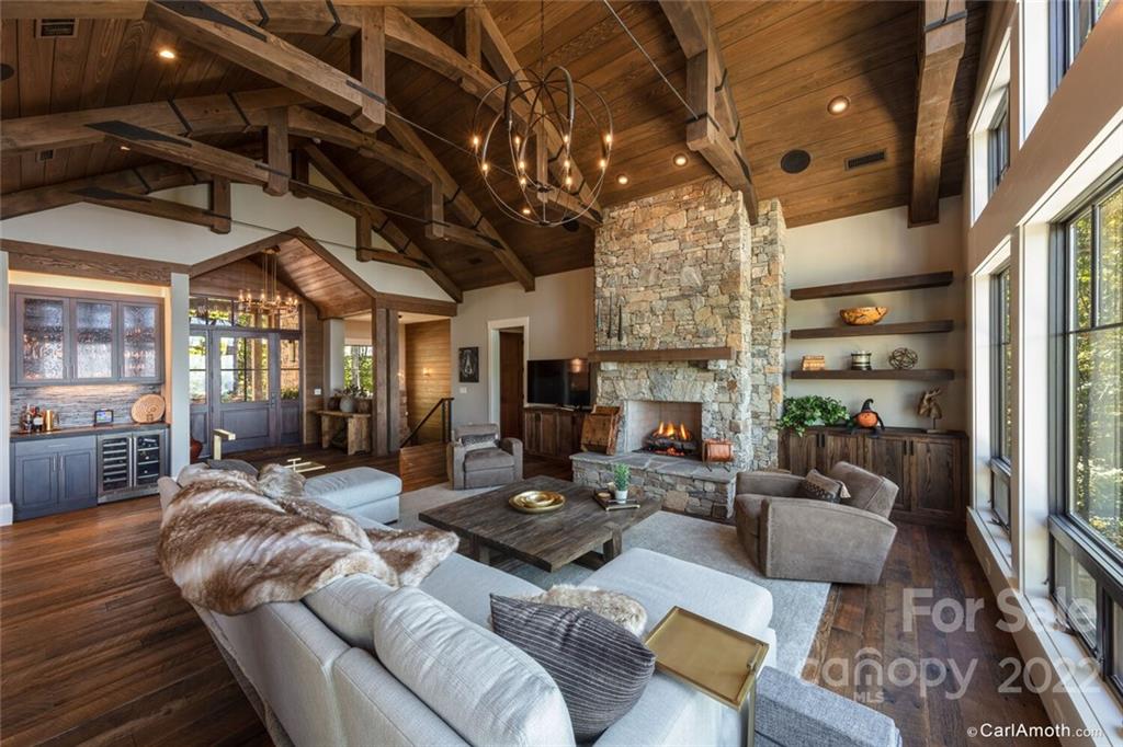 61 Back Bone Way, Unit 203 Sylva, NC 28779 - Photo 9 of 48 a living room with fireplace furniture and a chandelier