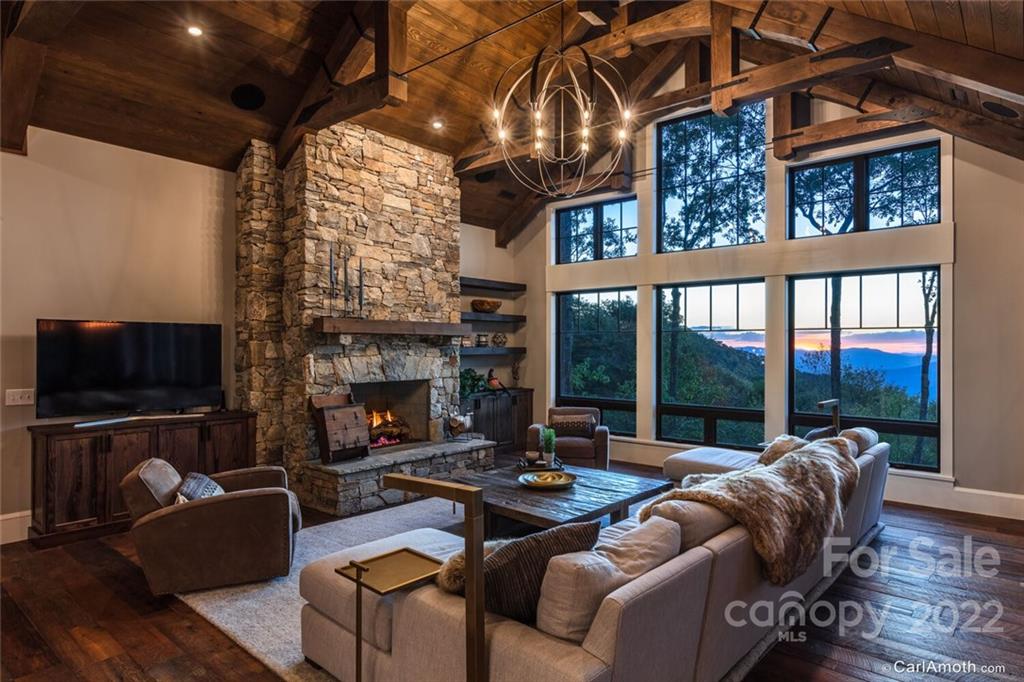 61 Back Bone Way, Unit 203 Sylva, NC 28779 - Photo 10 of 48 a living room with furniture a fireplace and a flat screen tv
