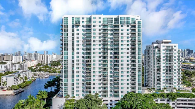 a view of a building with a garden and sitting area