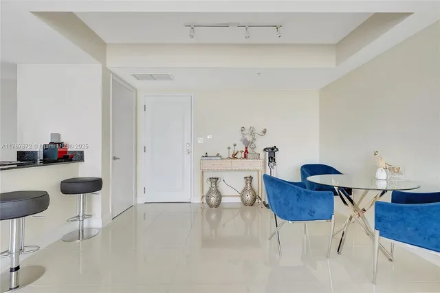 a kitchen with stainless steel appliances kitchen island granite countertop a refrigerator and a sink