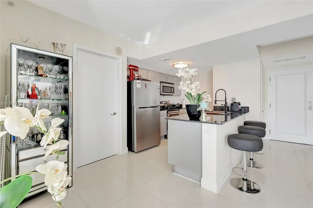 a kitchen with stainless steel appliances a sink stove and refrigerator