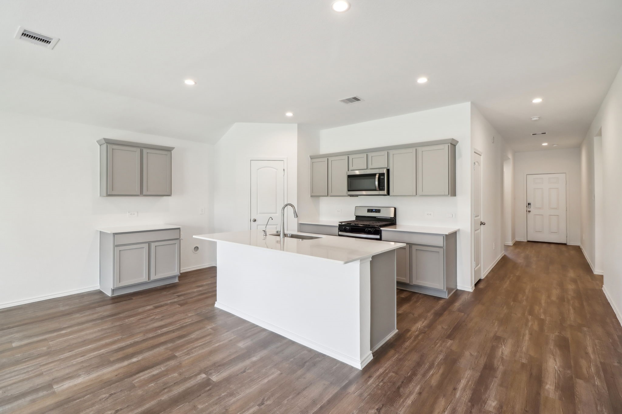 541 Wax Myrtle Way Hockley, TX 77447 - Photo 2 of 15 a kitchen with a sink a counter top space stainless steel appliances and cabinets