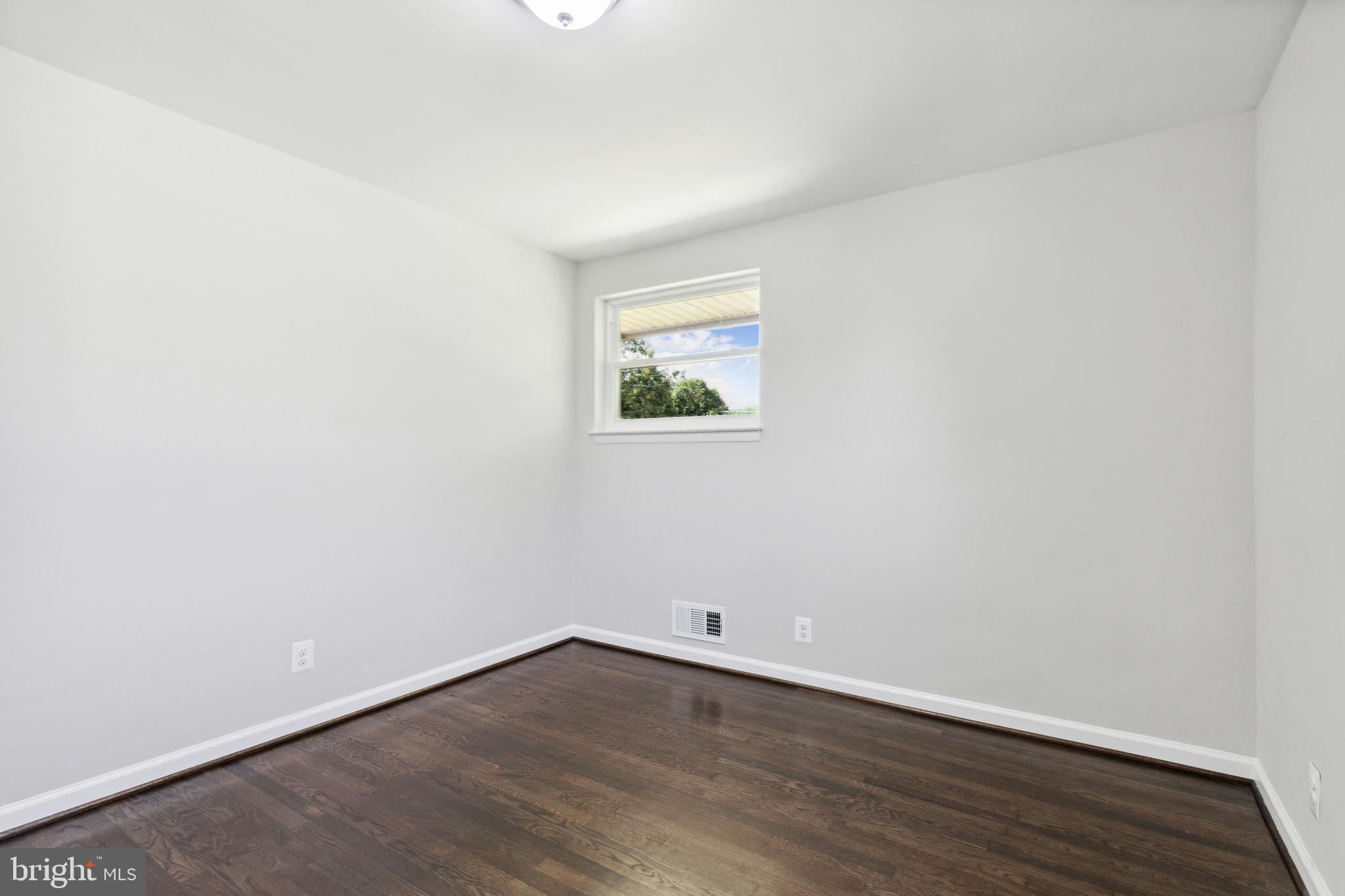4436 Ebenezer Road Nottingham, MD 21236 - Photo 23 of 51 an empty room with wooden floor and windows