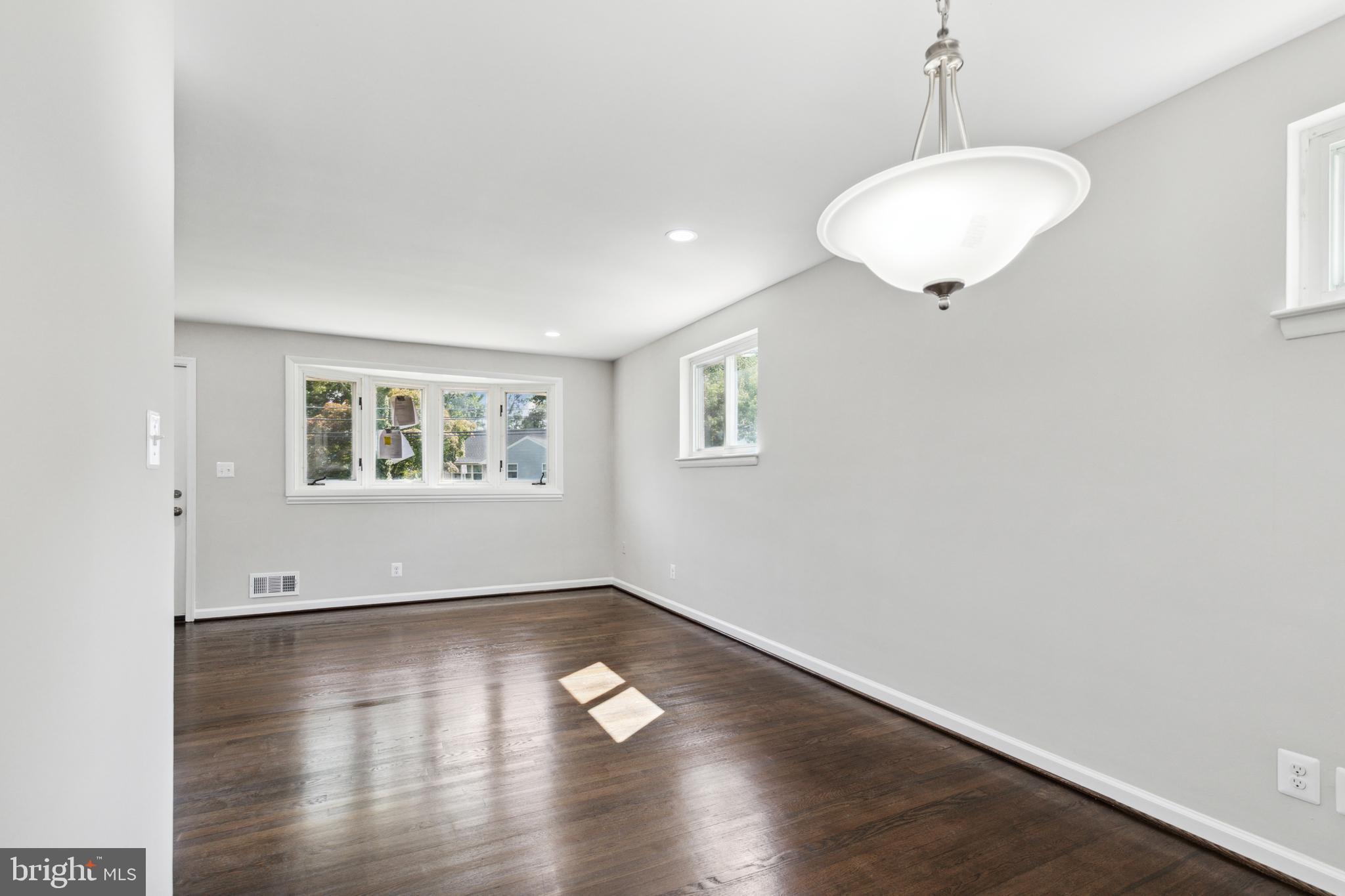 4436 Ebenezer Road Nottingham, MD 21236 - Photo 8 of 51 an empty room with wooden floor and windows