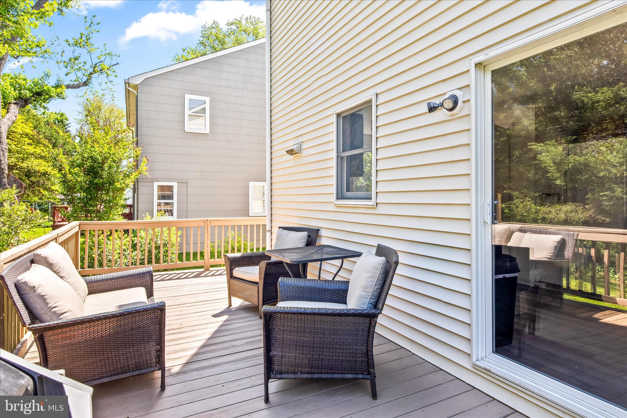 21406 Dogwood Cove Road Tilghman, MD 21671 - Photo 9 of 68 a balcony with wooden floor table and chairs