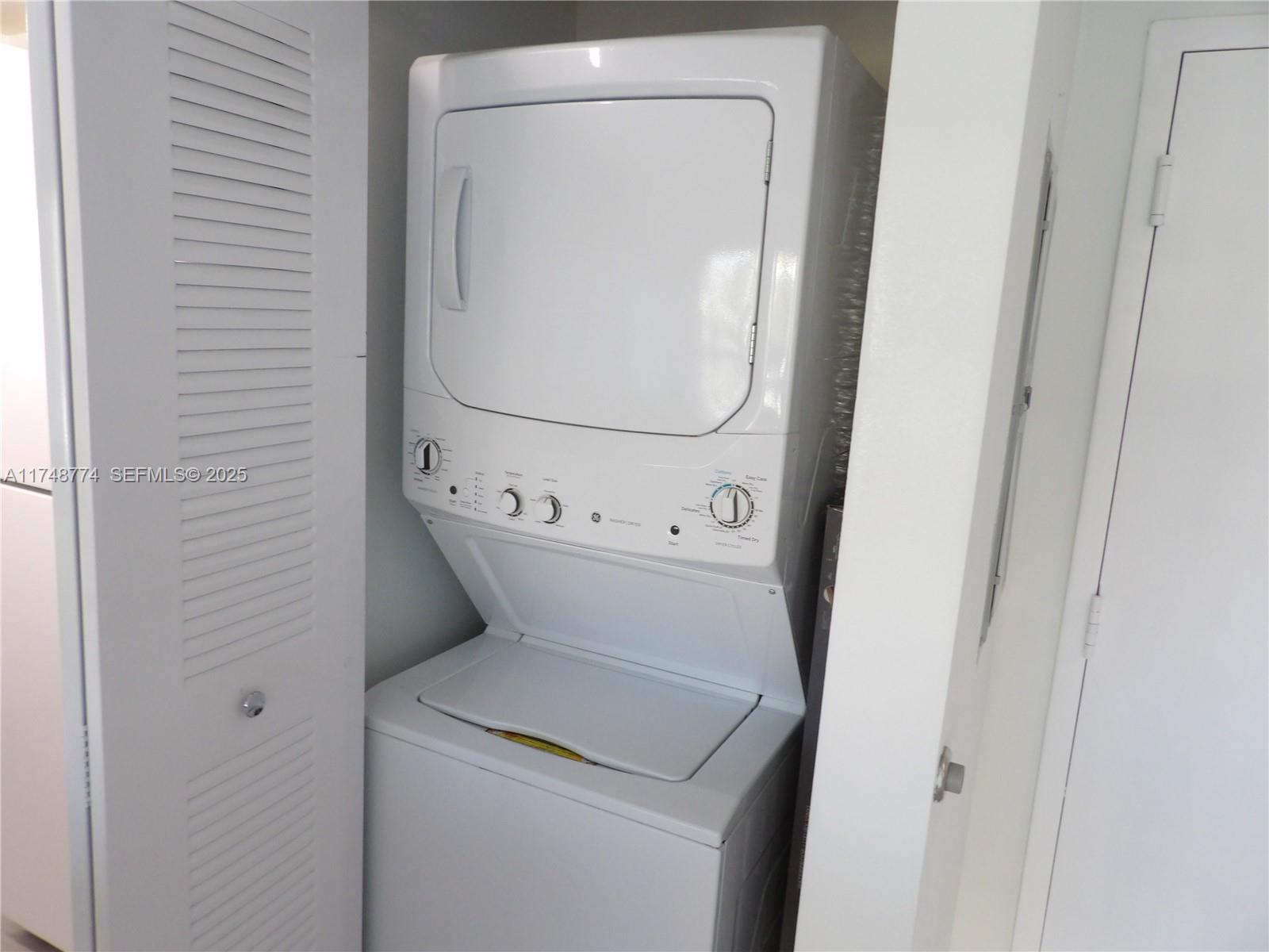 2740 Southwest 28th Terrace, Unit 301 Miami, FL 33133 - Photo 13 of 31 a utility room with dryer and washer