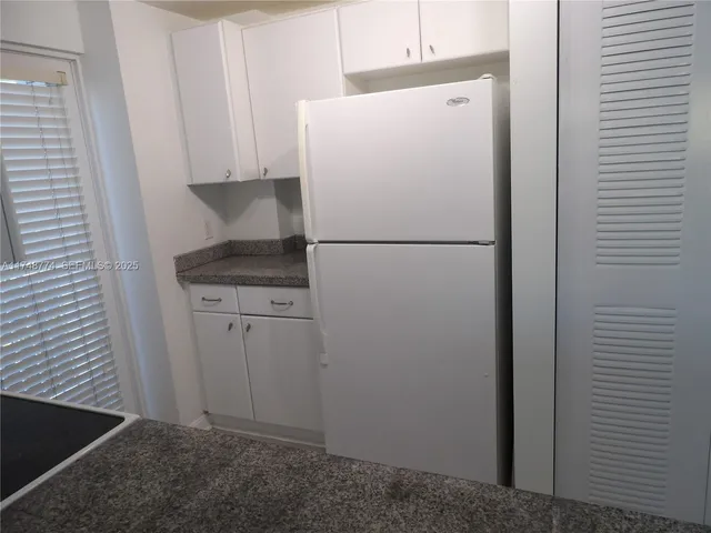 a white refrigerator freezer sitting in a kitchen