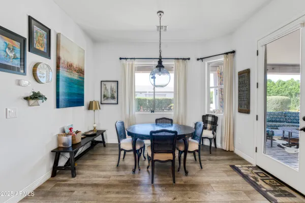 a view of a dining room with furniture window and wooden floor
