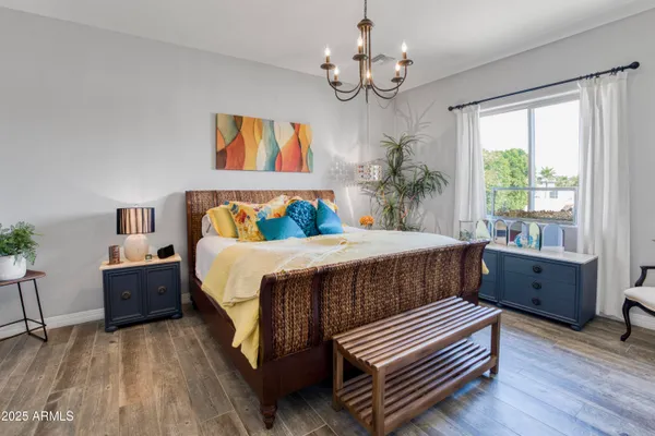 a bed room with a bed and a chandelier