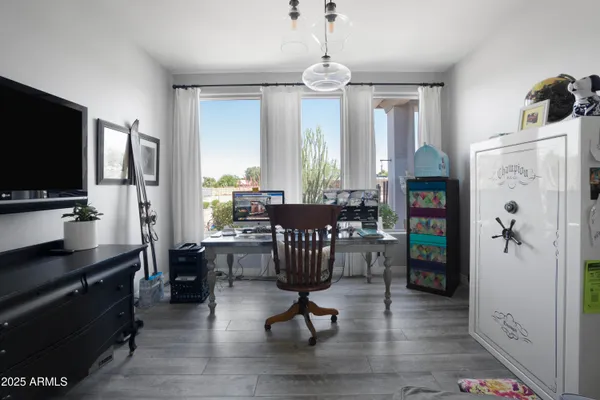 a view of a livingroom with furniture window and wooden floor