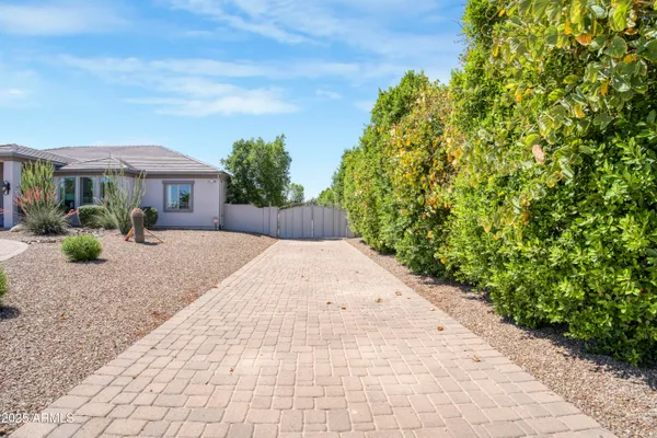 a front view of a house with a yard and potted plants