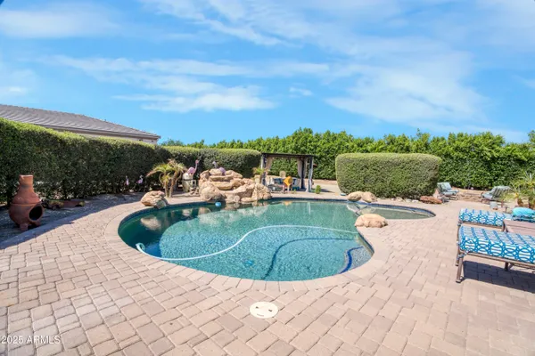 a view of a swimming pool with a yard