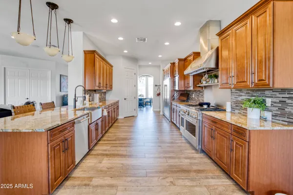 a kitchen with stainless steel appliances a sink and a large window