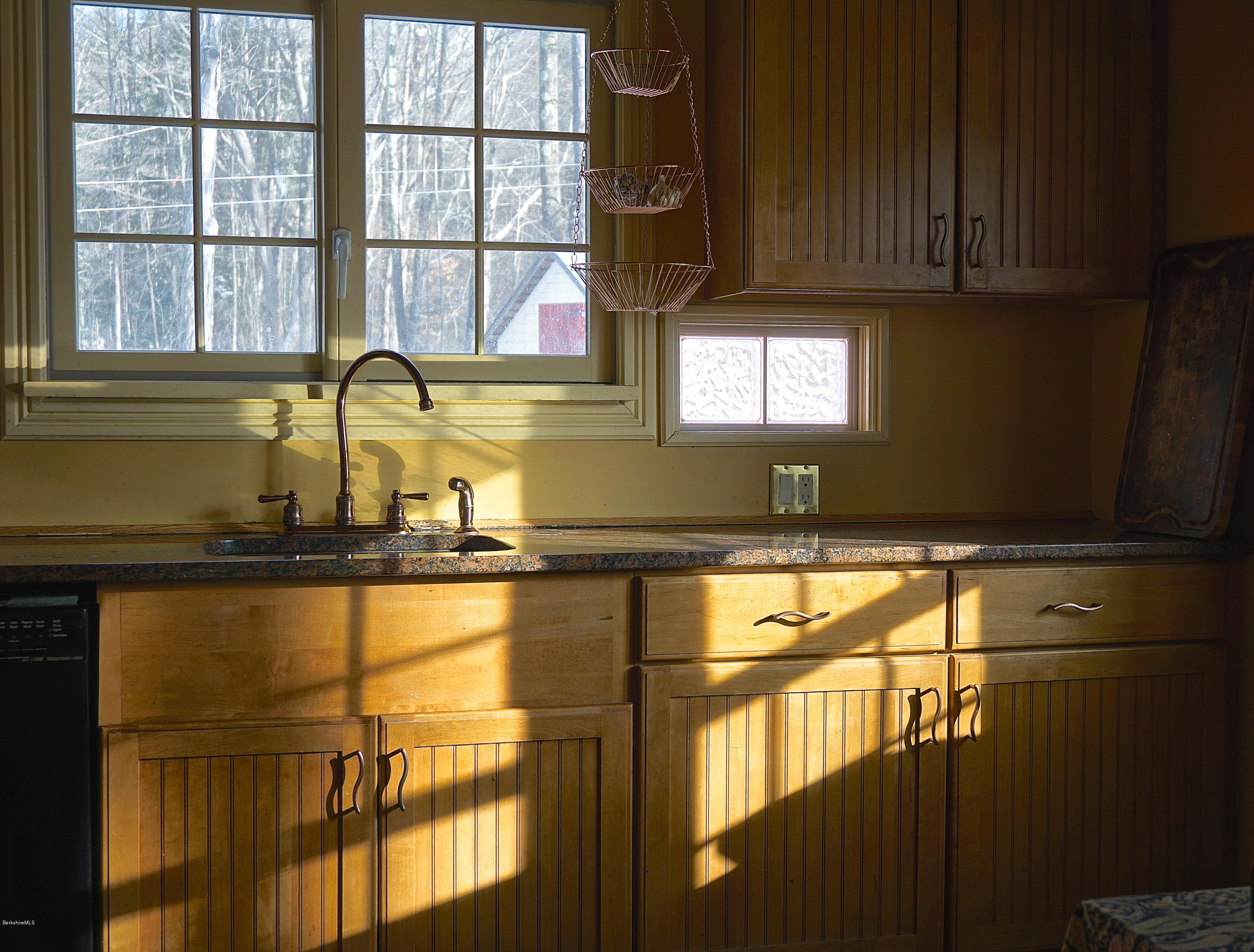 405 Main Road Monterey, MA 01245 - Photo 6 of 26 a kitchen with a sink window and cabinets