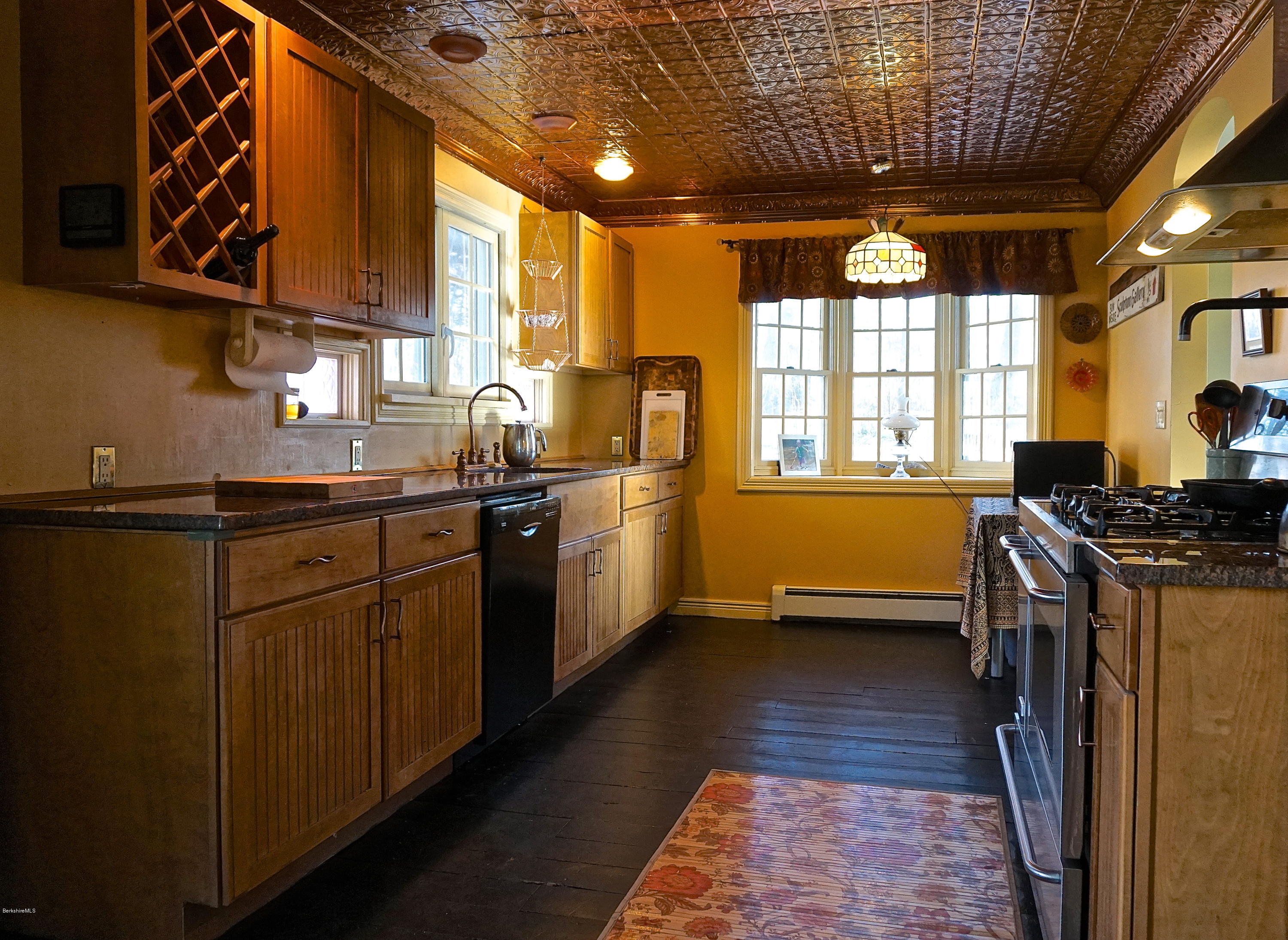405 Main Road Monterey, MA 01245 - Photo 7 of 26 a kitchen with stainless steel appliances granite countertop a sink a stove next to a window