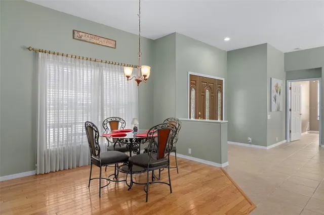 a view of a dining room with furniture and window