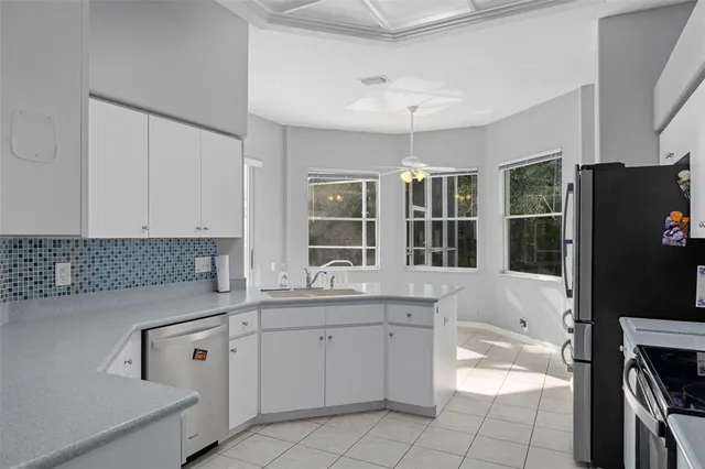 a kitchen with a sink stove and cabinets
