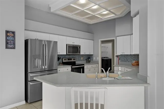 a kitchen with stainless steel appliances granite countertop a sink refrigerator and microwave