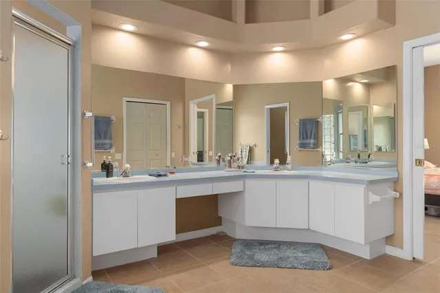 a large bathroom with a large mirror vanity and sink
