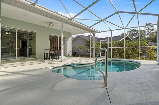 a swimming pool with outdoor seating