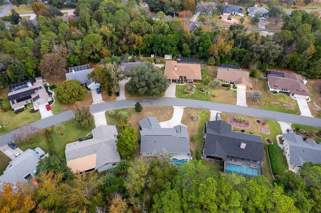 an aerial view of a house with a garden and swimming pool