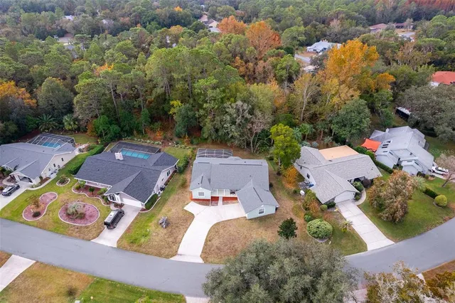 an aerial view of a house with yard swimming pool and outdoor seating