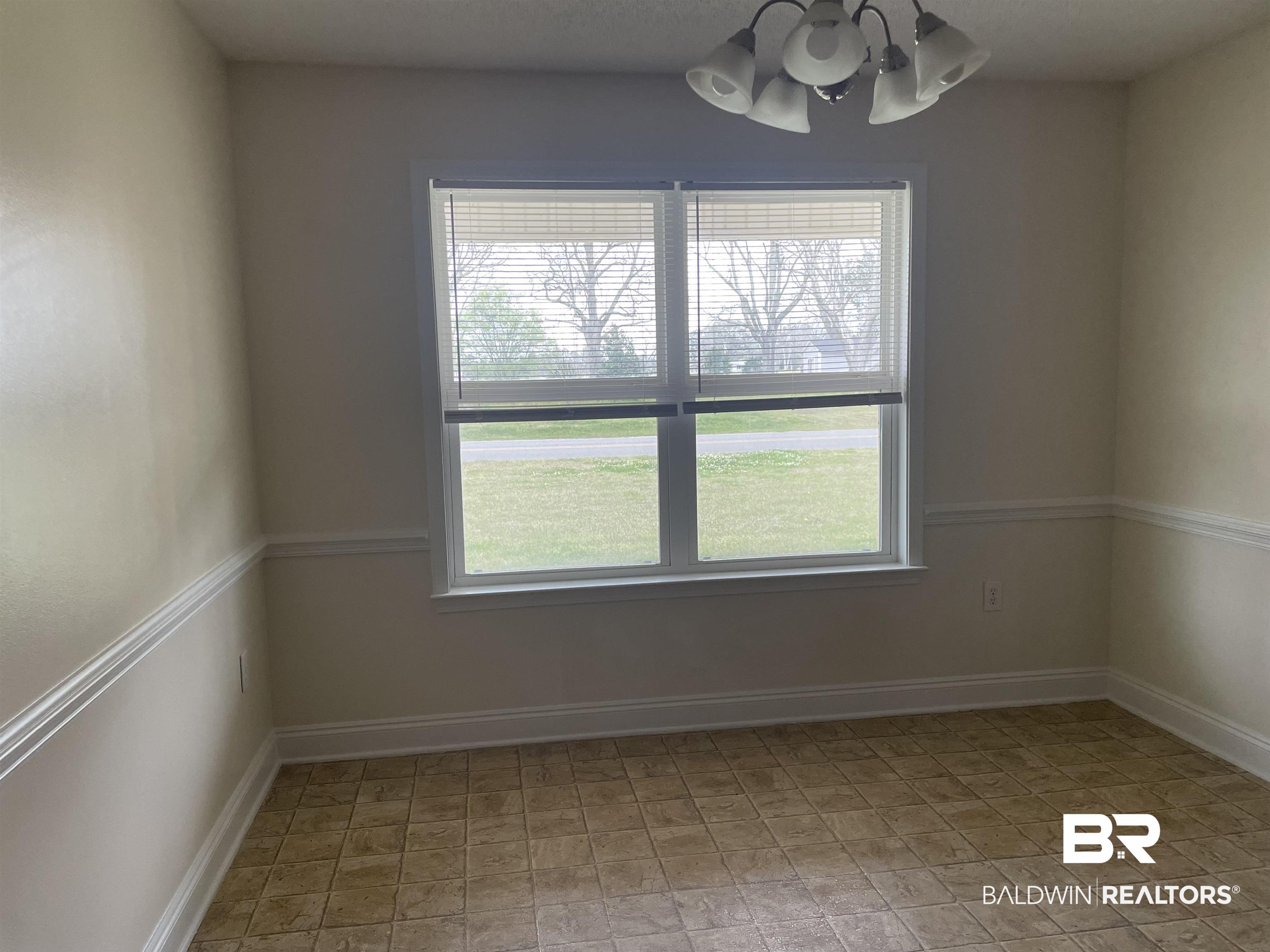23575 Fountain Street Robertsdale, AL 36567 - Photo 4 of 19 Breakfast room with baseboards and a chandelier
