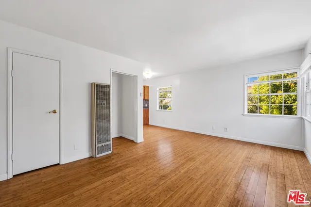 a view of a kitchen with a sink and dishwasher a refrigerator with wooden floor