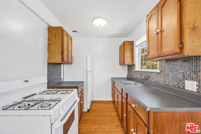 a kitchen that has a sink and a stove