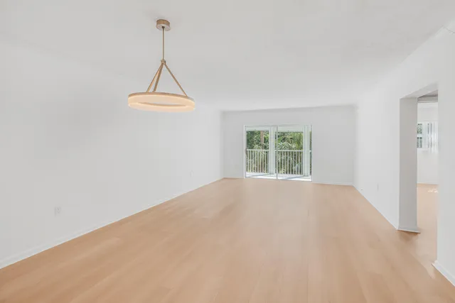 a view of a room with a window and a ceiling fan