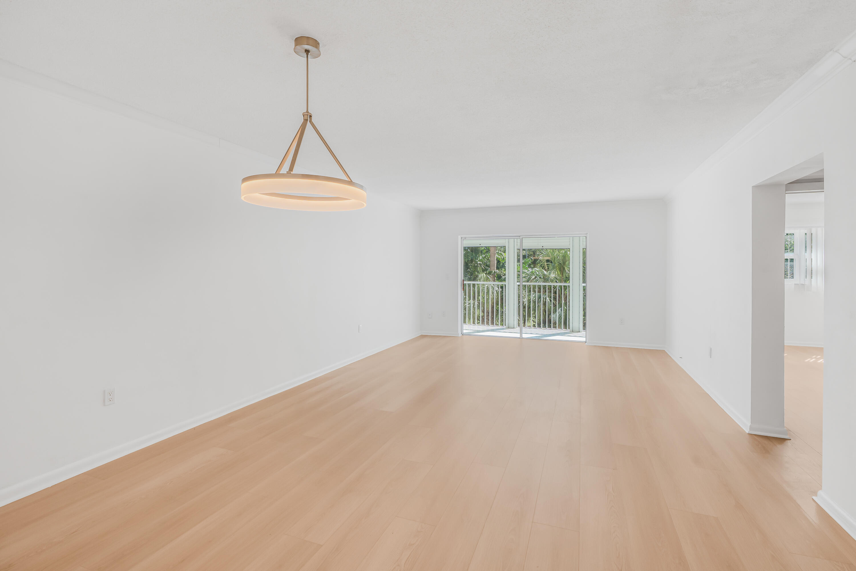 a view of a room with a window and a ceiling fan