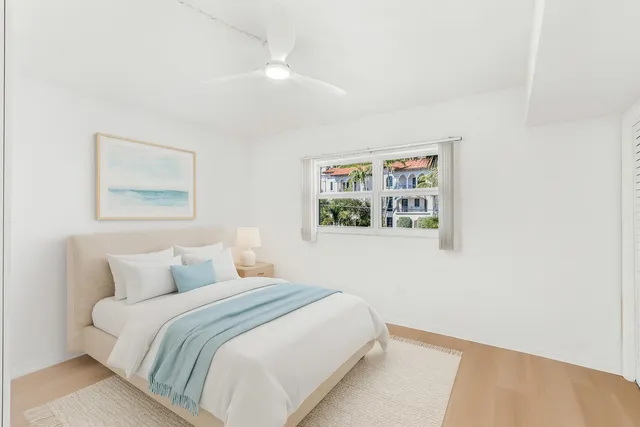 a bedroom with a bed and a painting on the wall