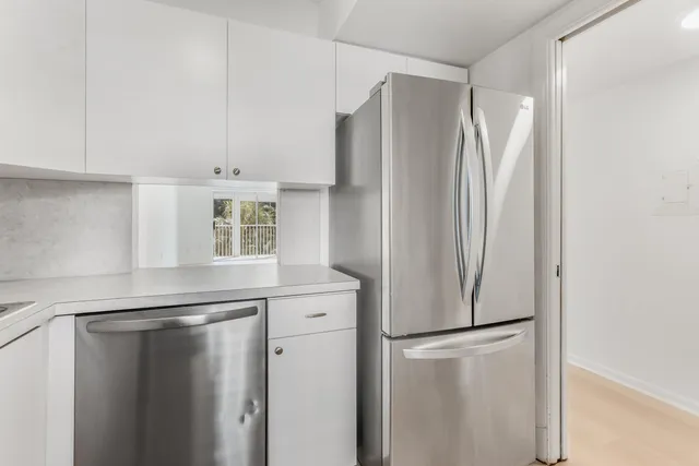 a white refrigerator freezer sitting inside of a kitchen