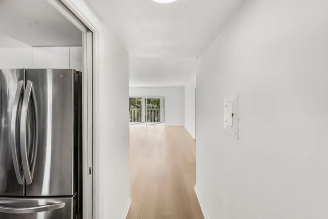 a view of a kitchen with refrigerator and windows