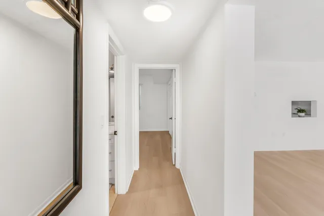 a view of a hallway with wooden floor
