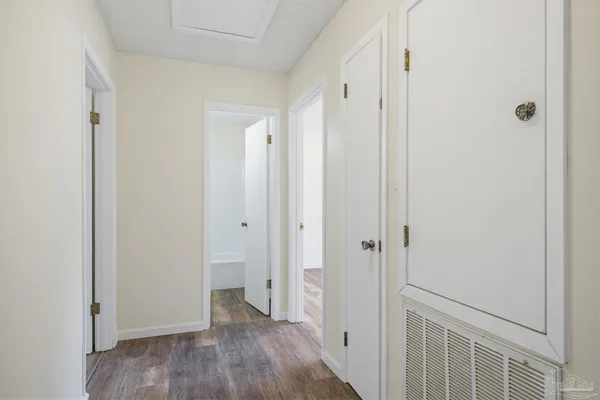 a view of a hallway with wooden floor