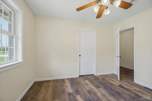 a view of empty room with wooden floor