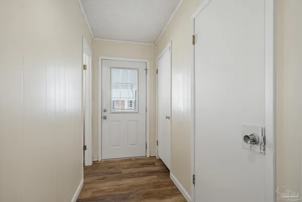 a view of a hallway with wooden floor