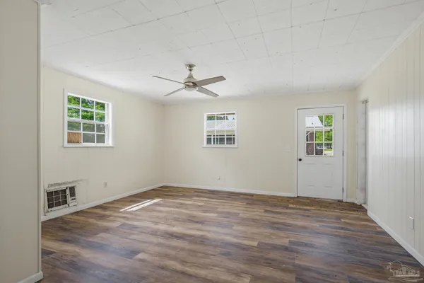 wooden floor in an empty room with a window