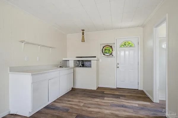 a view of a kitchen with fridge and wooden floor
